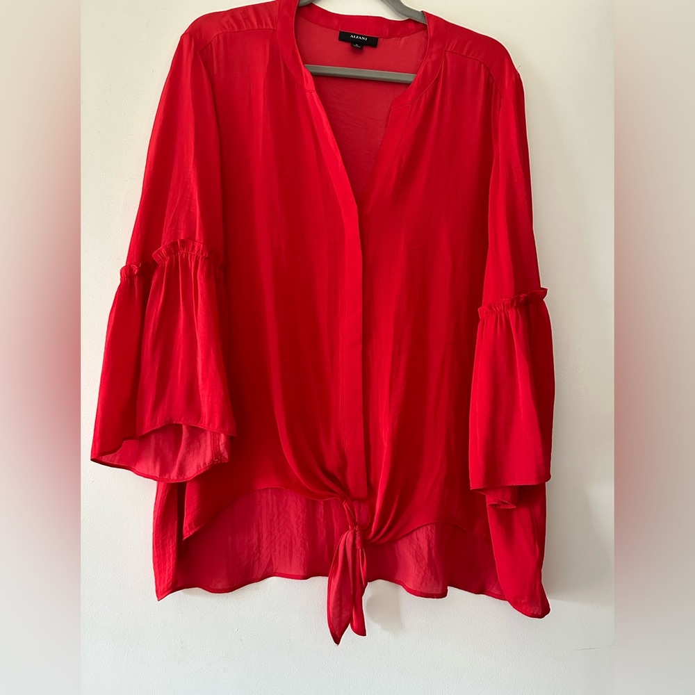 So pretty top with ruffles on sleeves and tie at bottom